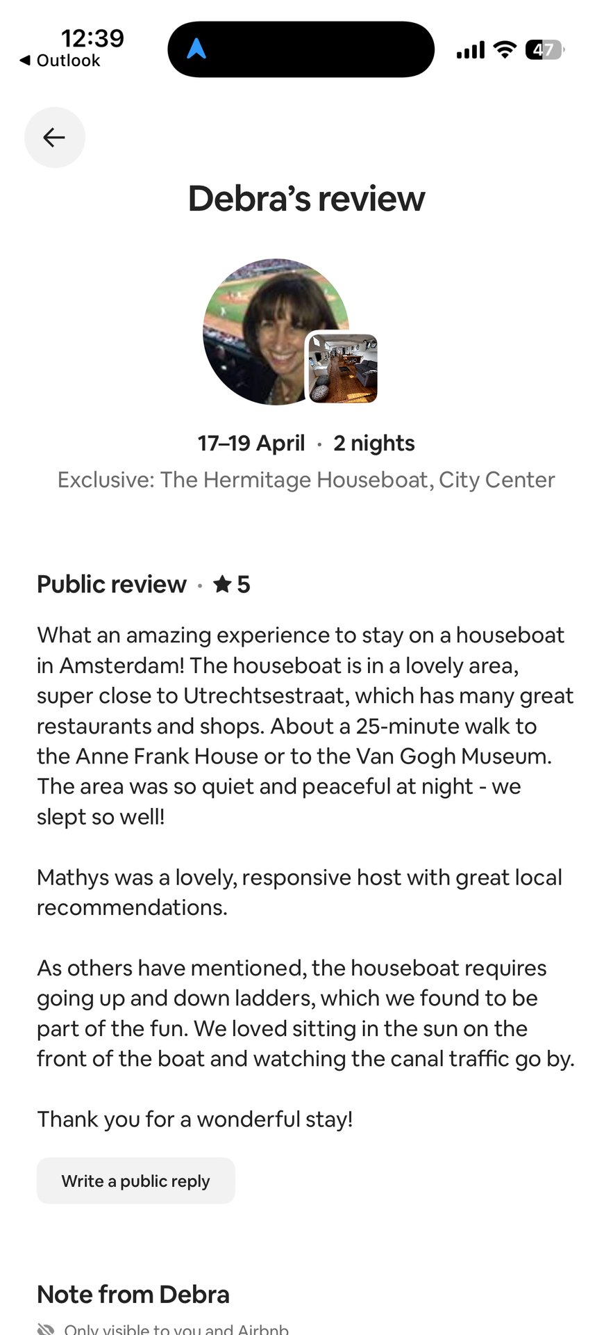 This image displays a mobile phone screen showing a 5-star review from Debra for 'The Hermitage Houseboat' in Amsterdam